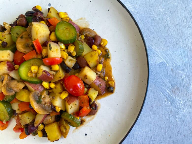 Cooked vegetable hash on a white plate